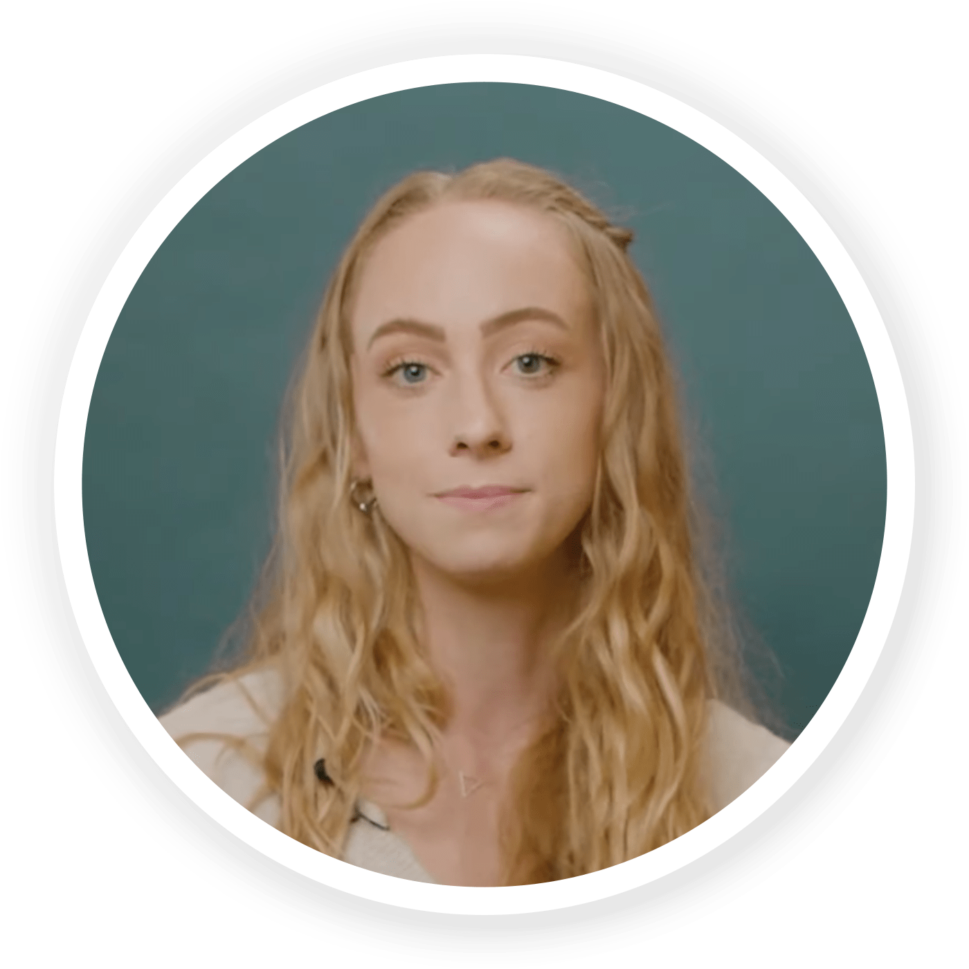 Profile of Kiley Norvell in a light-colored shirt on a dark blue-green background